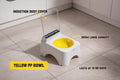 Small white and yellow pet toilet on a tiled floor with text highlighting features.